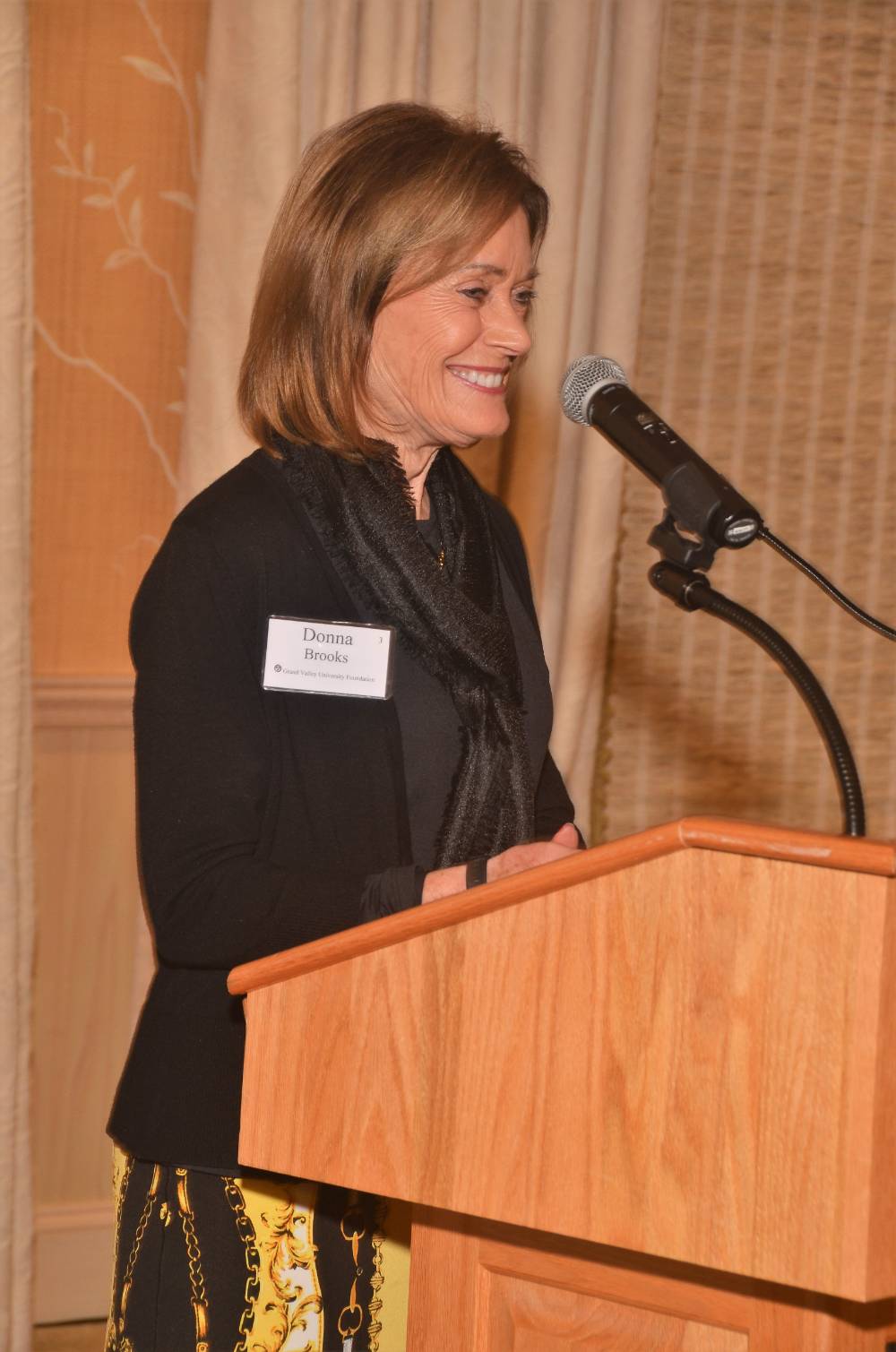 Donna Brooks speaking at a podium.